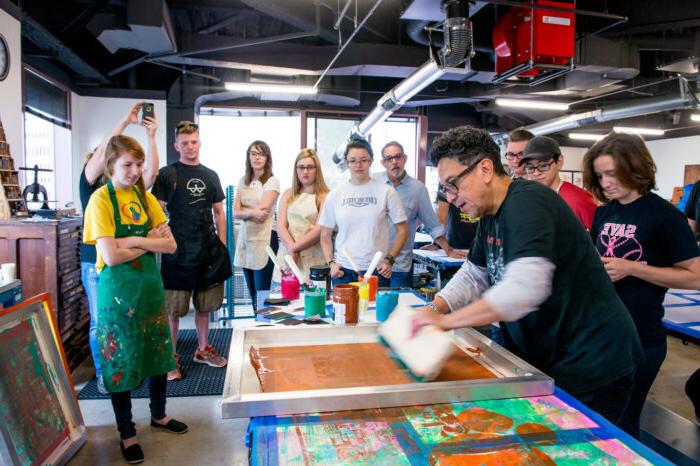 Professor actively engaged in a demonstration with students.