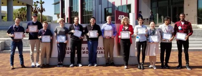 Students pose with their award certificates.