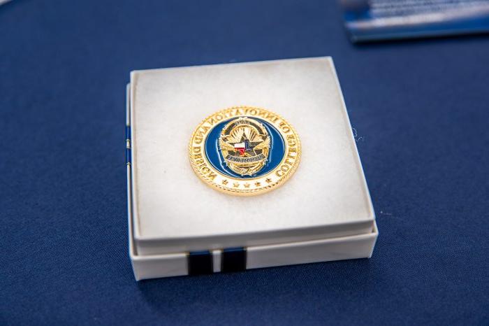 A commemorative coin inside a jewelry box.