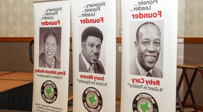 Vertical floor banners portray the three founders of the Texas Association of Black Personnel in Higher Education.